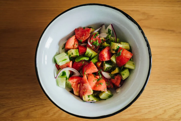 Bowl of cucumber tomato onion salad.