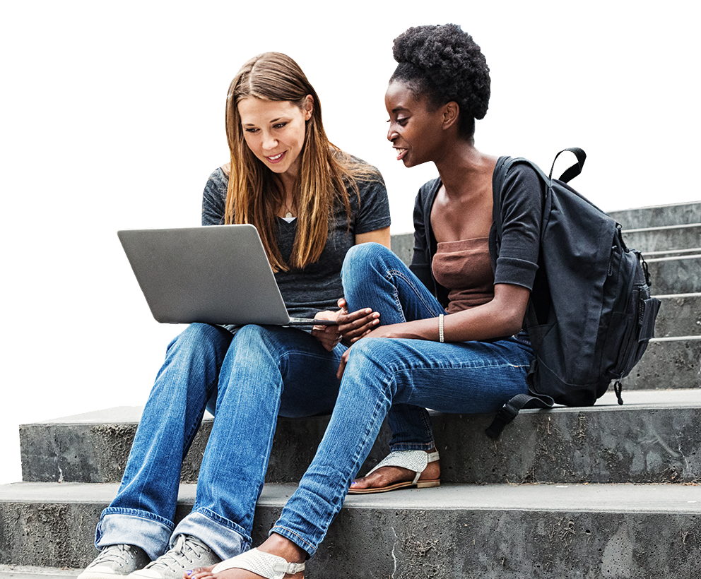 Two female college students sitting on stairs with a laptop