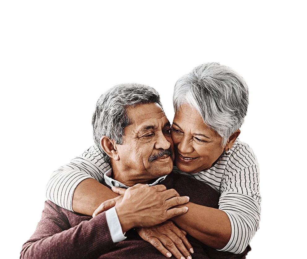 Elderly couple embracing eachother with a smile.