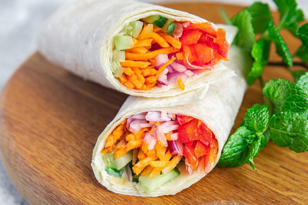 Tortilla wraps with carrots, bell peppers, onions and cucumbers. 