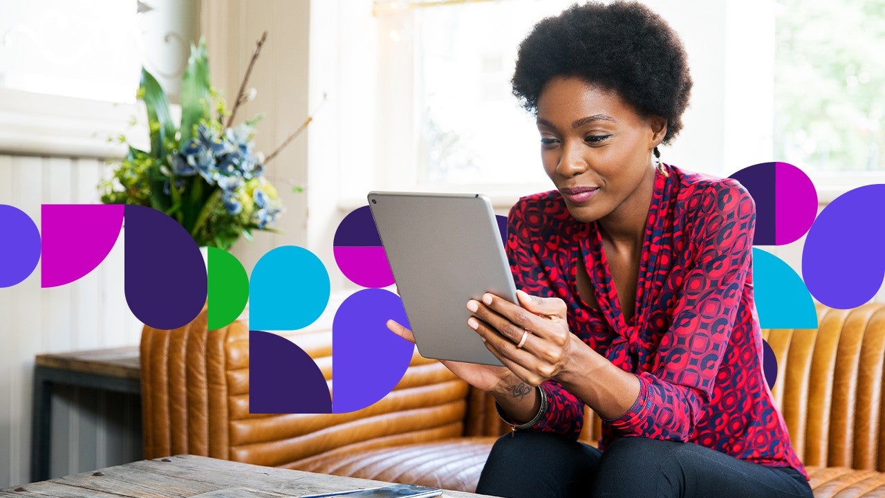  Woman sitting on couch looking at tablet