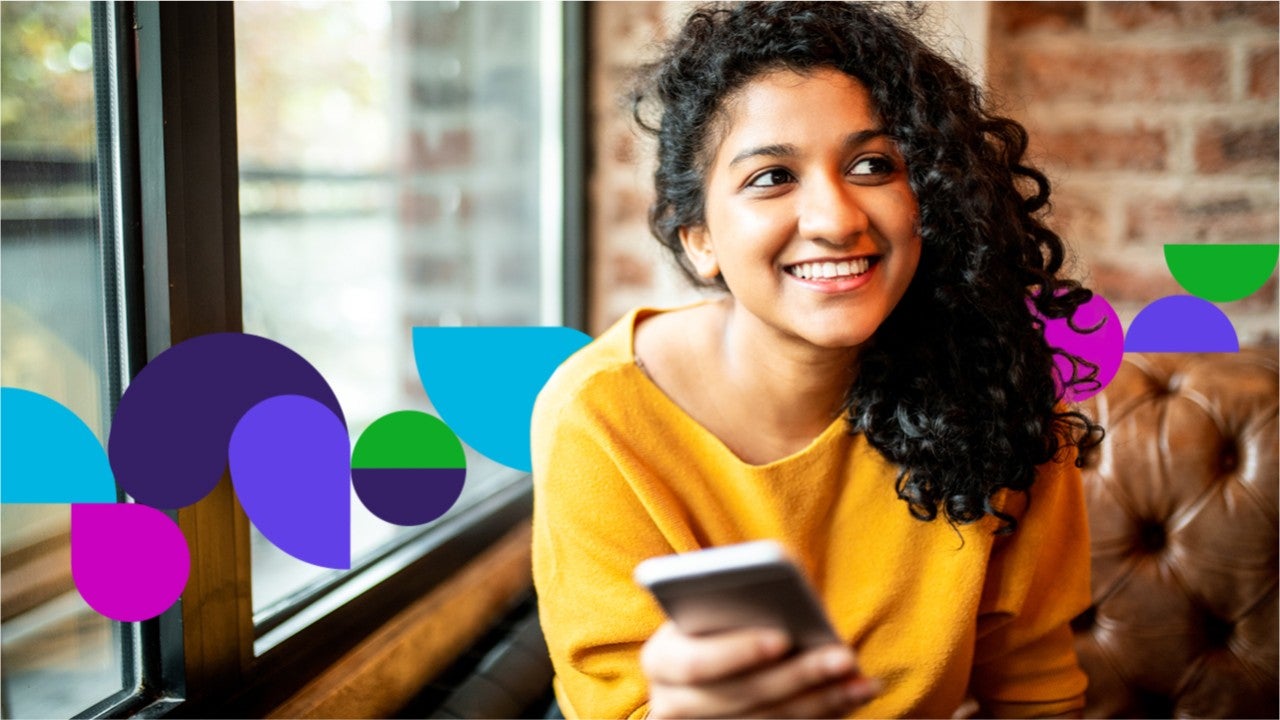 Woman smiling holding a phone