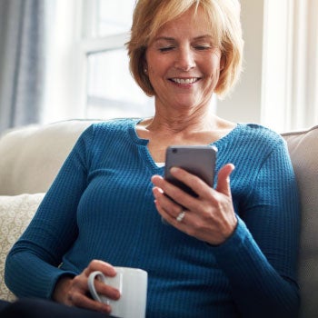 Woman sitting on a couch using her phone 