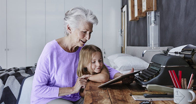Grandma doing a puzzle with a little.