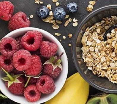 Various examples of carbohydrates including oats, raspberries, and blueberries
