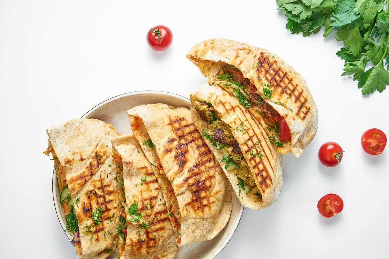 Whole wheat pita filled with chopped vegetables and feta cheese salad