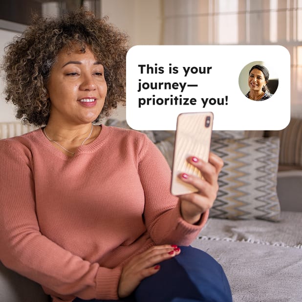 Woman sitting looking at mobile phone with word bubble saying "This is your journey--prioritize you!"