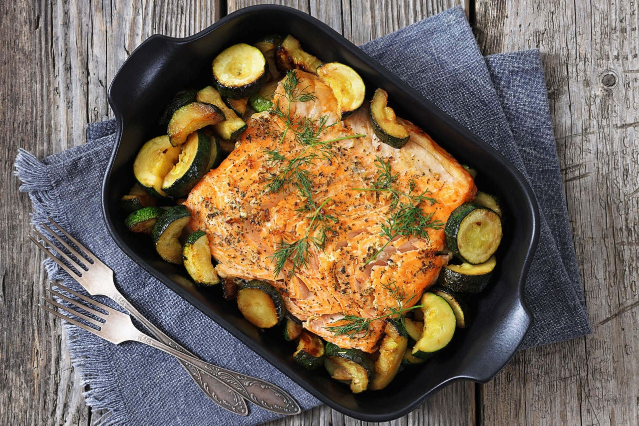 Grilled salmon fillet served with sliced zucchini