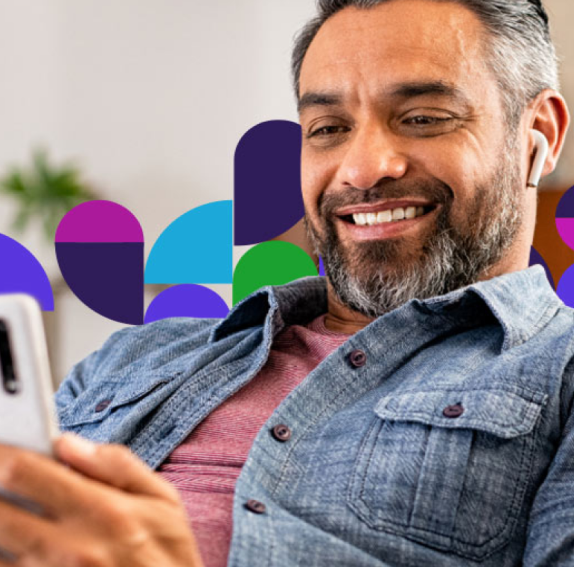middle-aged man looking at phone smiling