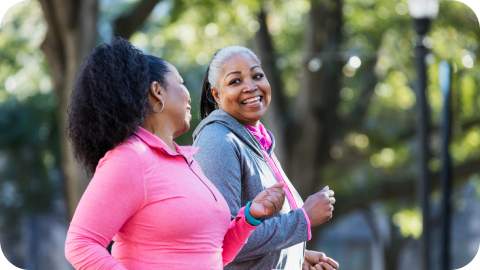 Two women in workout clothes exercising