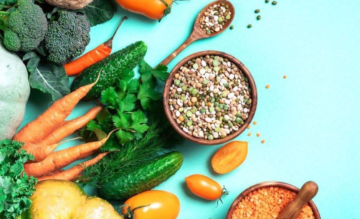 A colorful display of fresh vegetables, grains, and lentils
