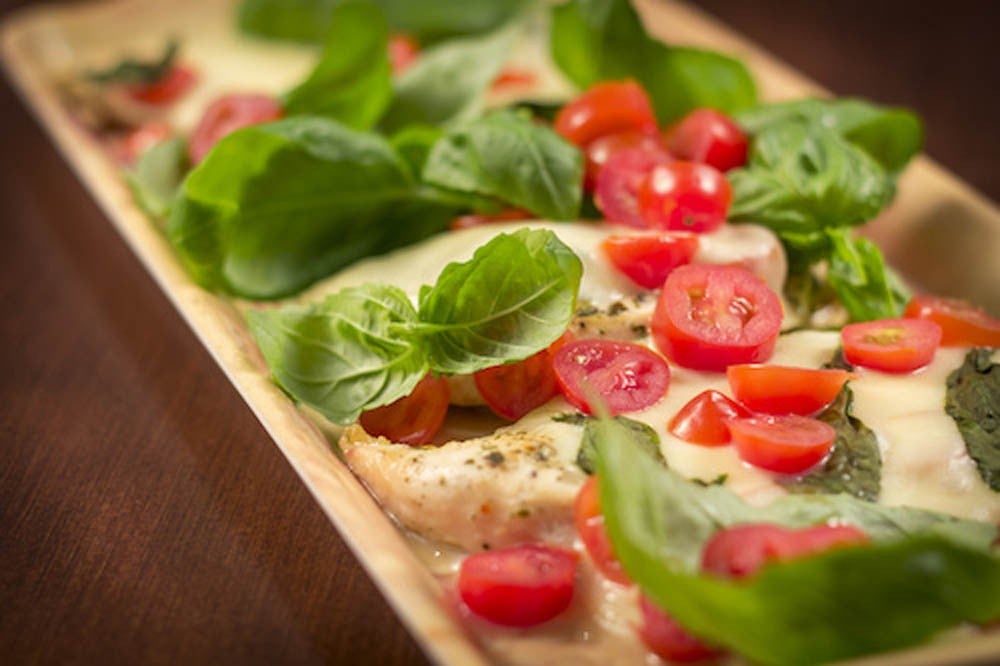 Grilled caprese chicken with mozzarella cheese basil and tomatoes