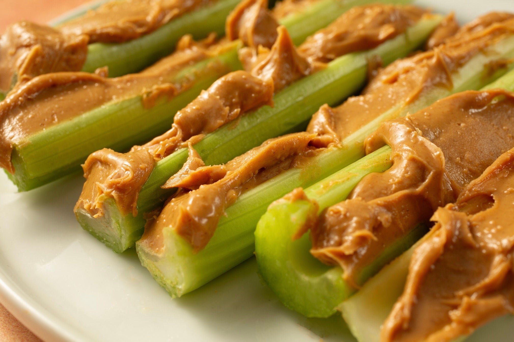Row of celery sticks topped with peanut butter.