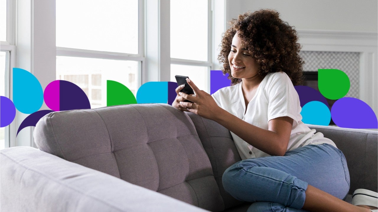 Woman on couch using cell phone
