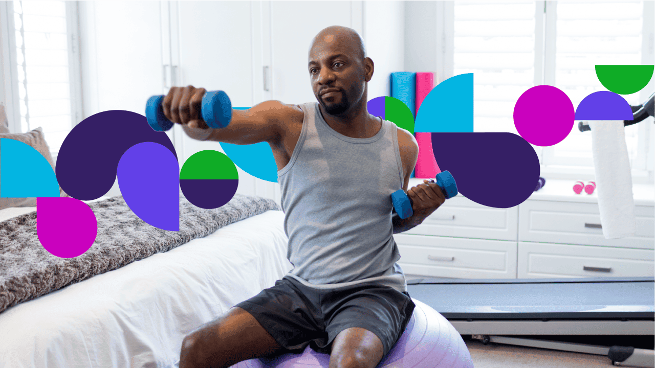 Man sitting on exercise ball doing exercise with weights
