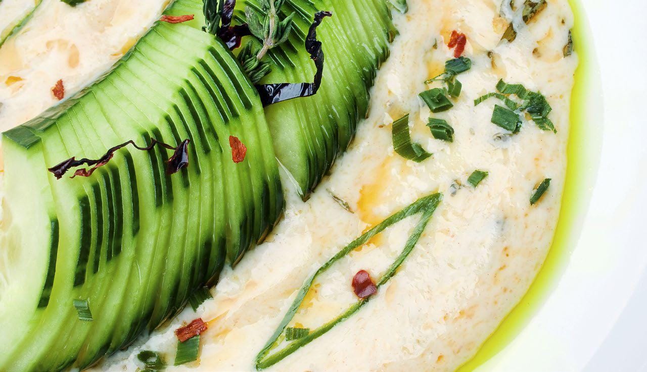 Cucumber slices dipped in dill hummus