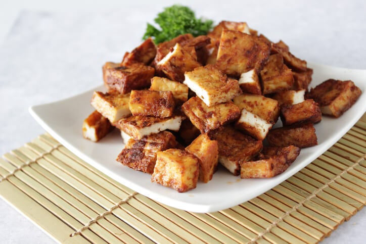 Pile of fried tofu bites on a plate.