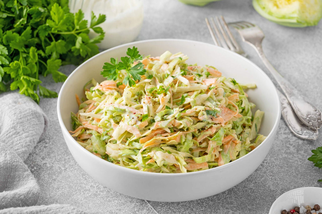 Apple and cabbage coleslaw in a bowl.