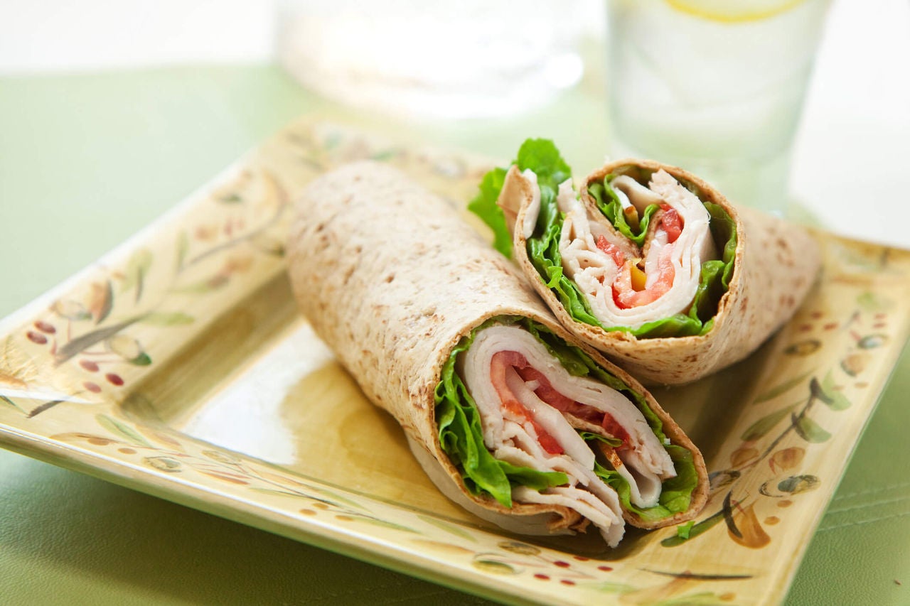 Sliced turkey, spinach and cheese in a whole grain wrap.