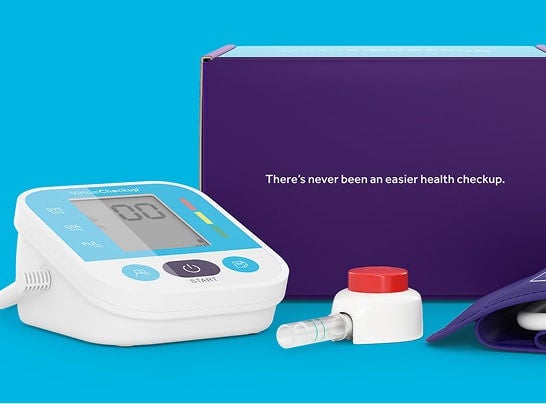 VirtualCheckup® at-home kit box with the blood collection device and instructions laid out