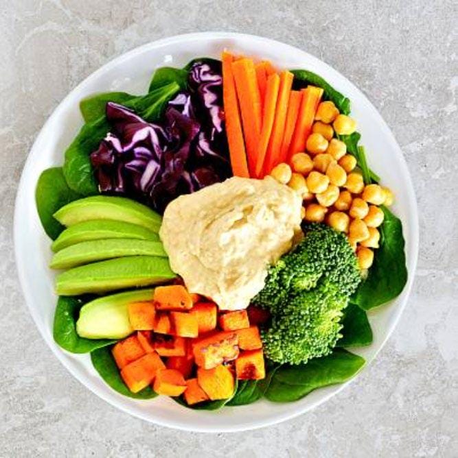A bowl with assorted vegetables, cauliflower, carrots, broccoli, cabbage, corn..