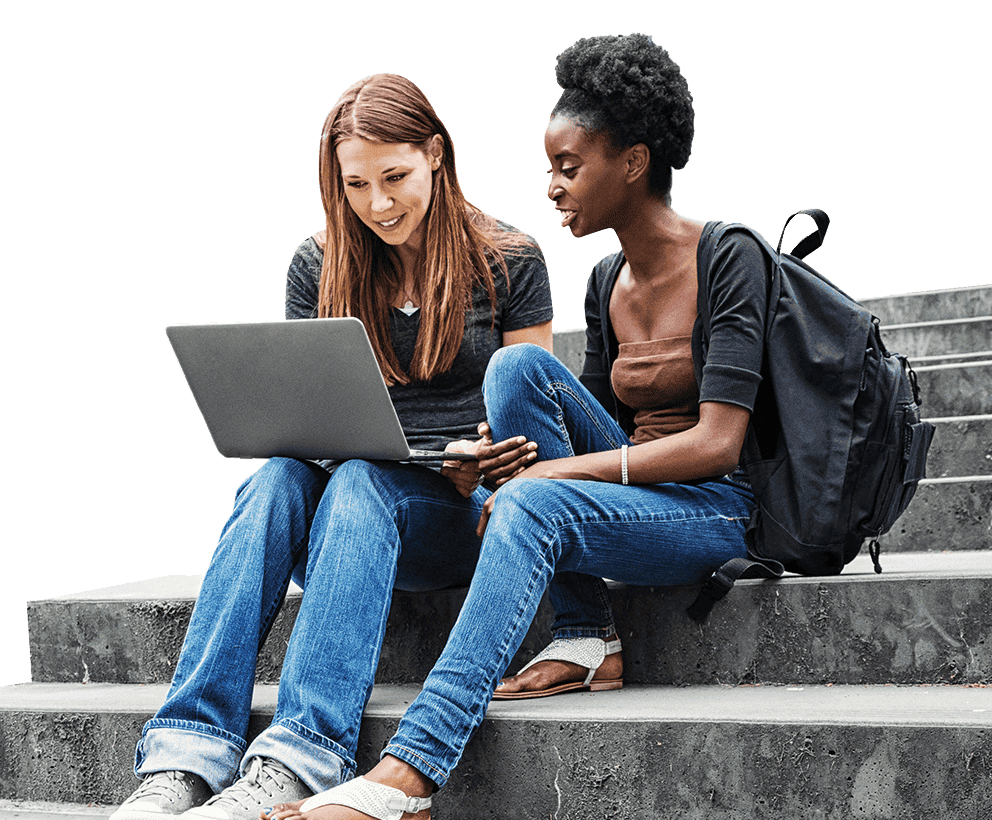 Two female college students sitting on stairs with a laptop