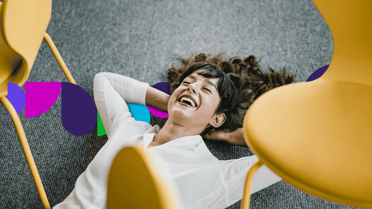 Woman lying on the floor between two chairs