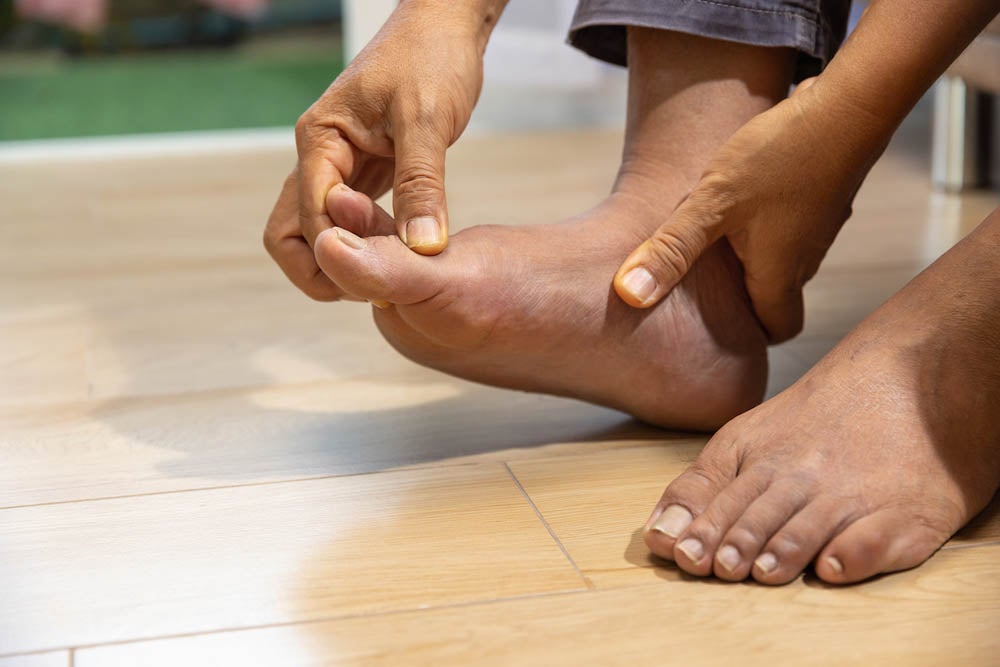 Senior Man massage foot with painful swollen gout inflammation