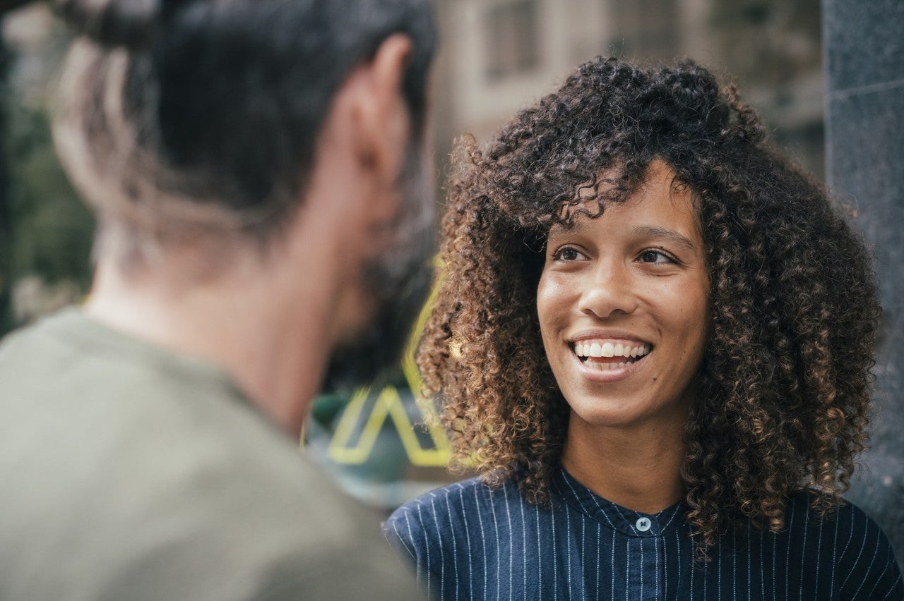 Two people having a friendly conversation outdoors.