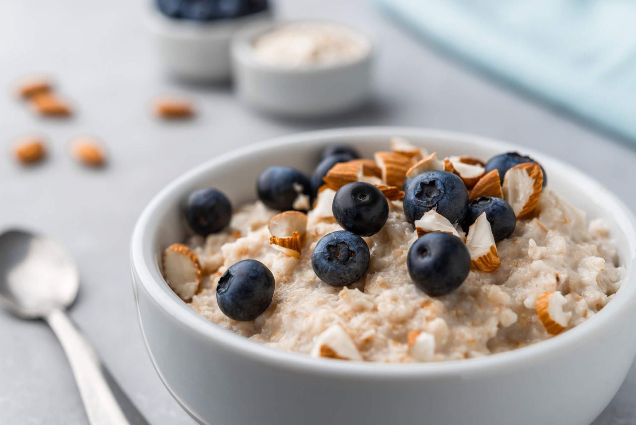 Bowl of oatmeal topped with fresh blueberries and almonds