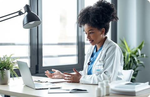 Two professionals reviewing information on a tablet in an office setting.