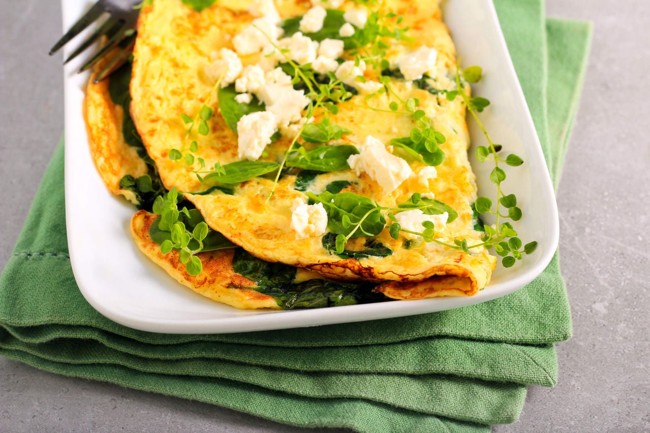 Omelet with greens and crumbled feta.