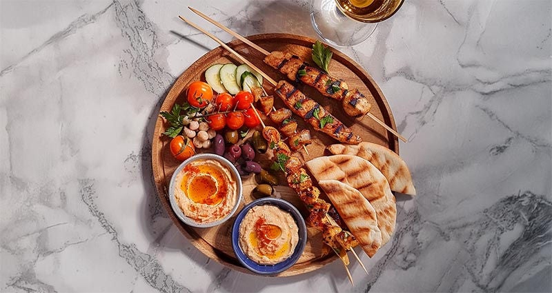 Mezze platter of mixed proteins and vegetables.
