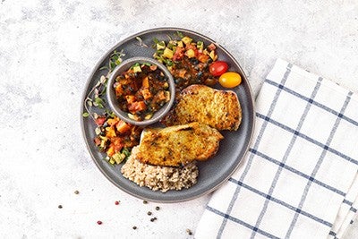 Fried beef steak with peach fruit salsa, tomato and chili. Medium or Rare fried steak cut into pieces. Ready to eat. Top view.
