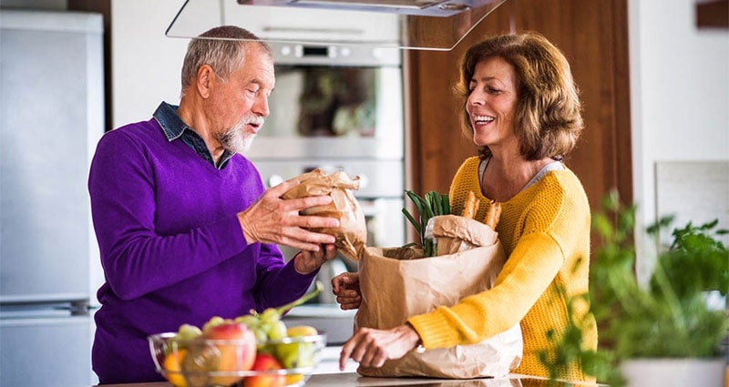 Healthy couple with vegetables (white)
