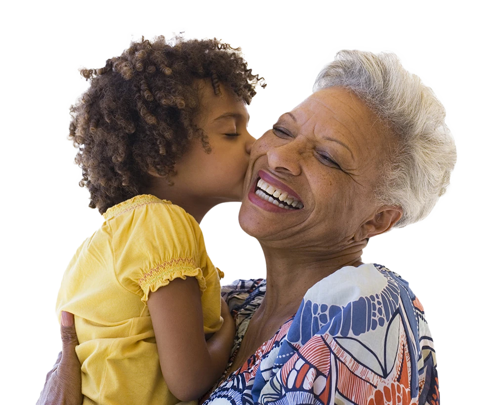 Kid kissing his grandmother in the cheek