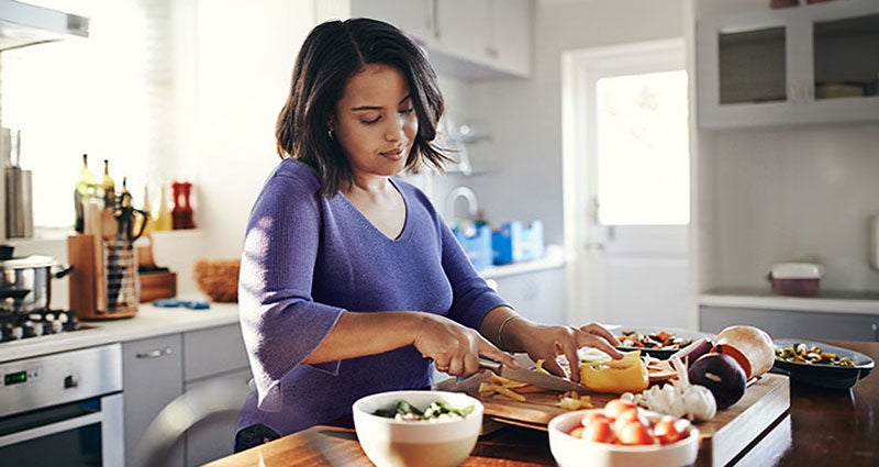 Young black woman preparing dinner