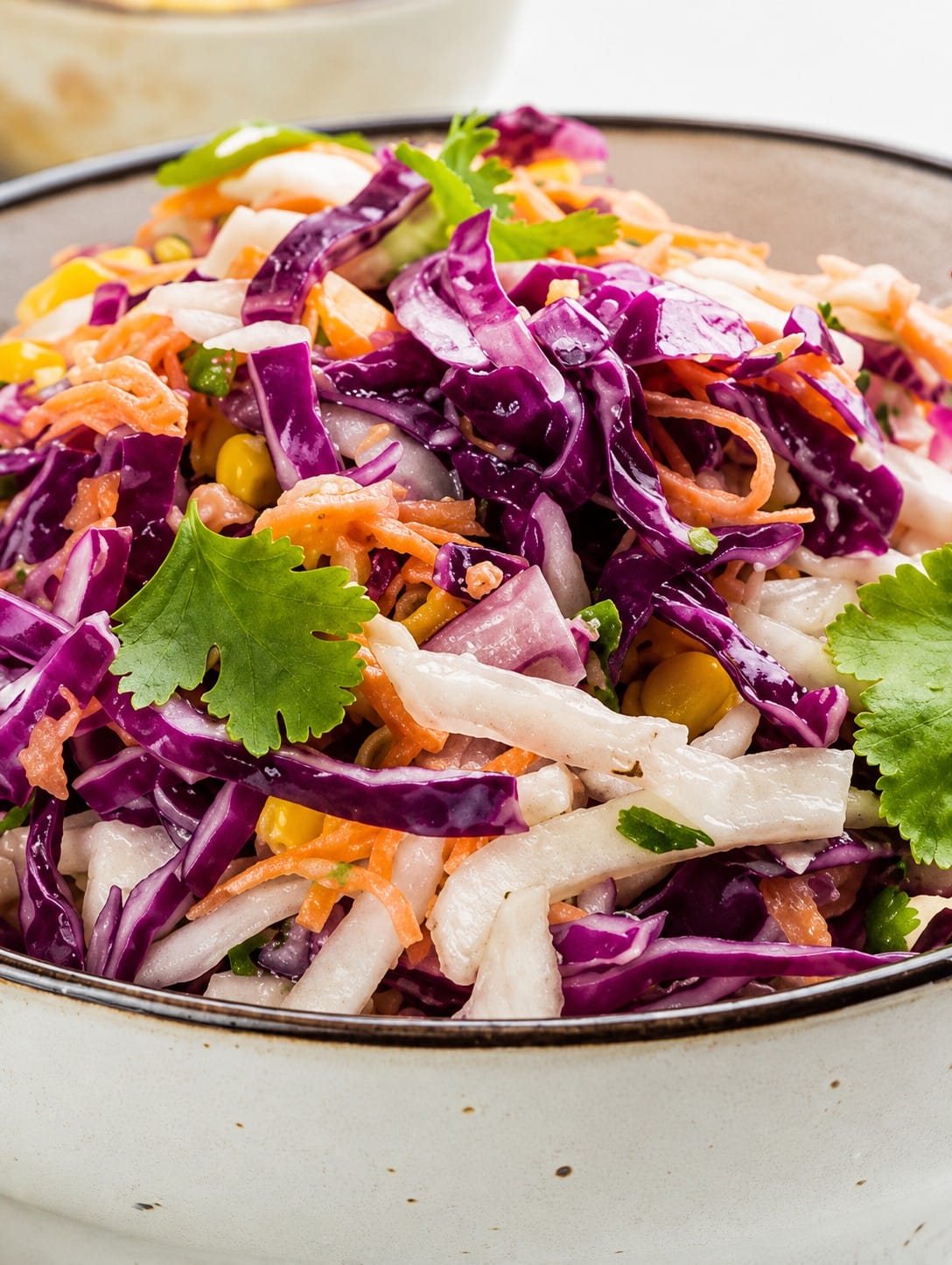 Crunchy slaw salad with salmon in a bowl