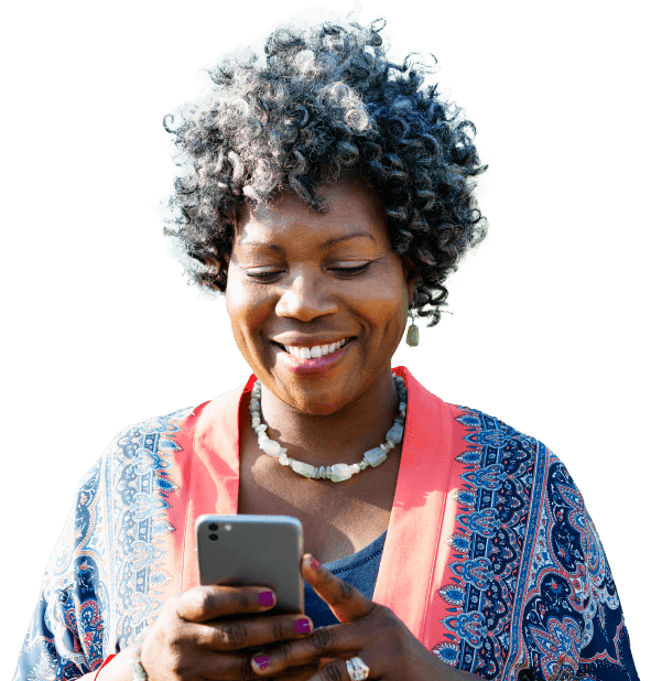 Woman smiling while looking at her phone