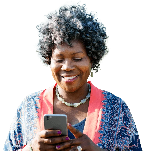 Woman smiling while looking at her phone