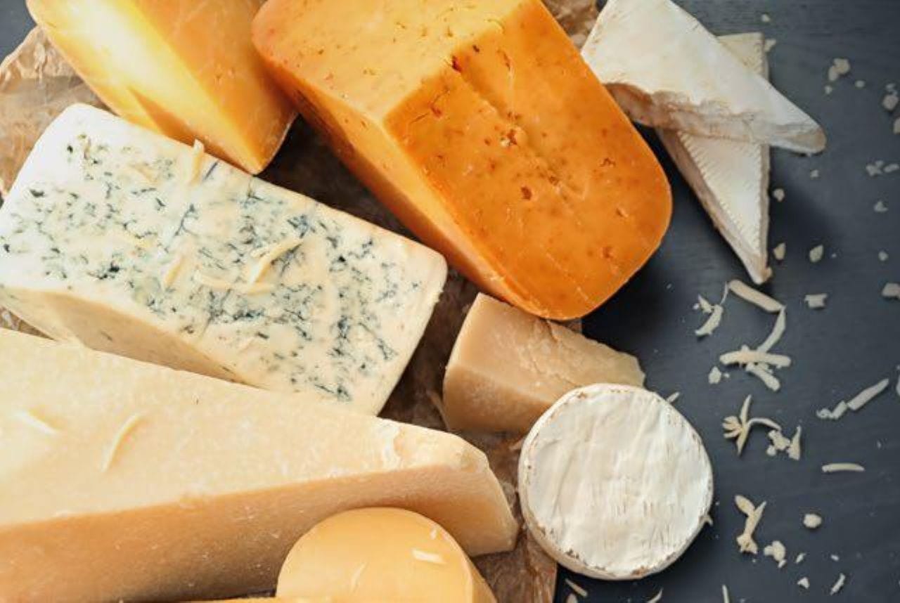 Assorted cheeses on a grey table