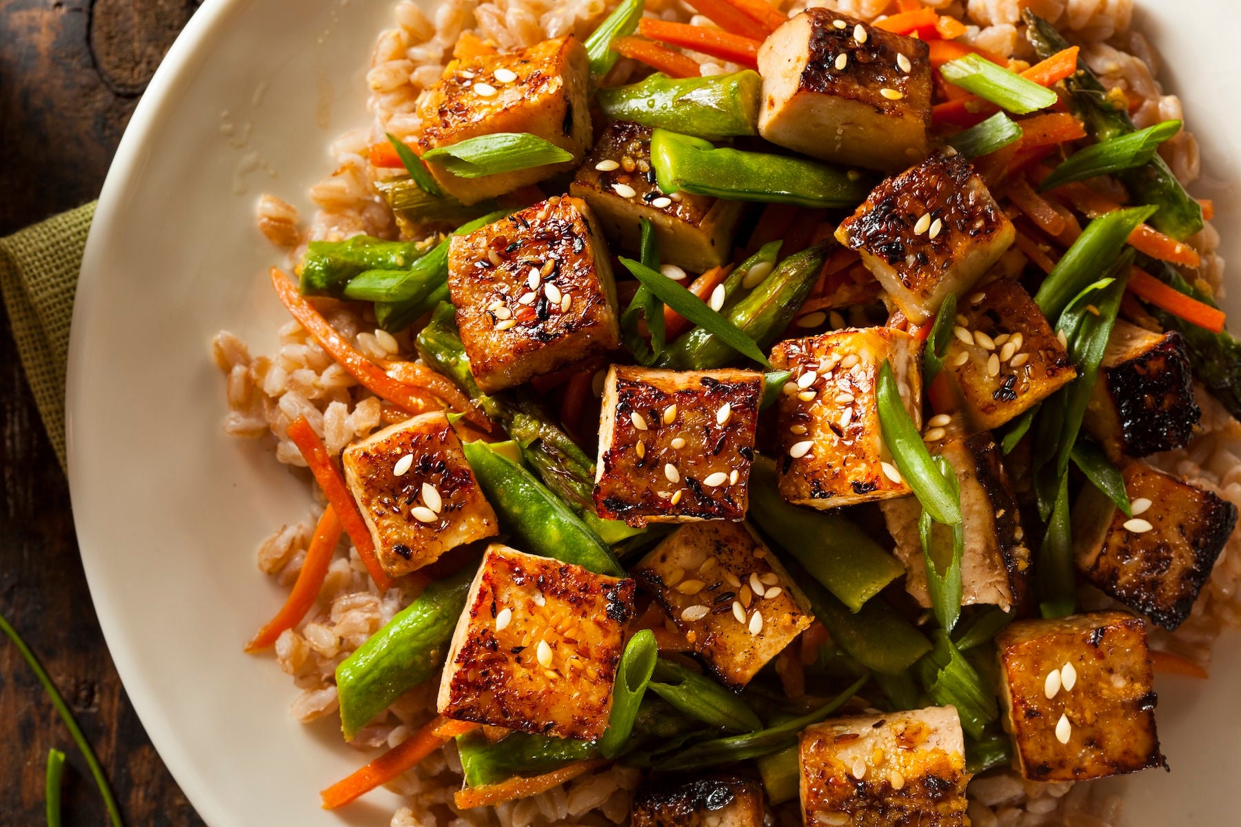 Seasoned tofu cubes over rice and mixed vegetables.