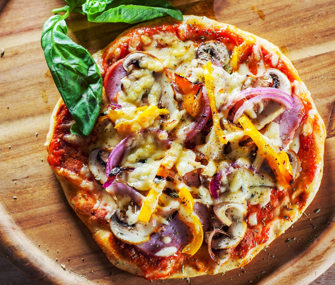 Pizza with mushrooms, peppers and onions.
