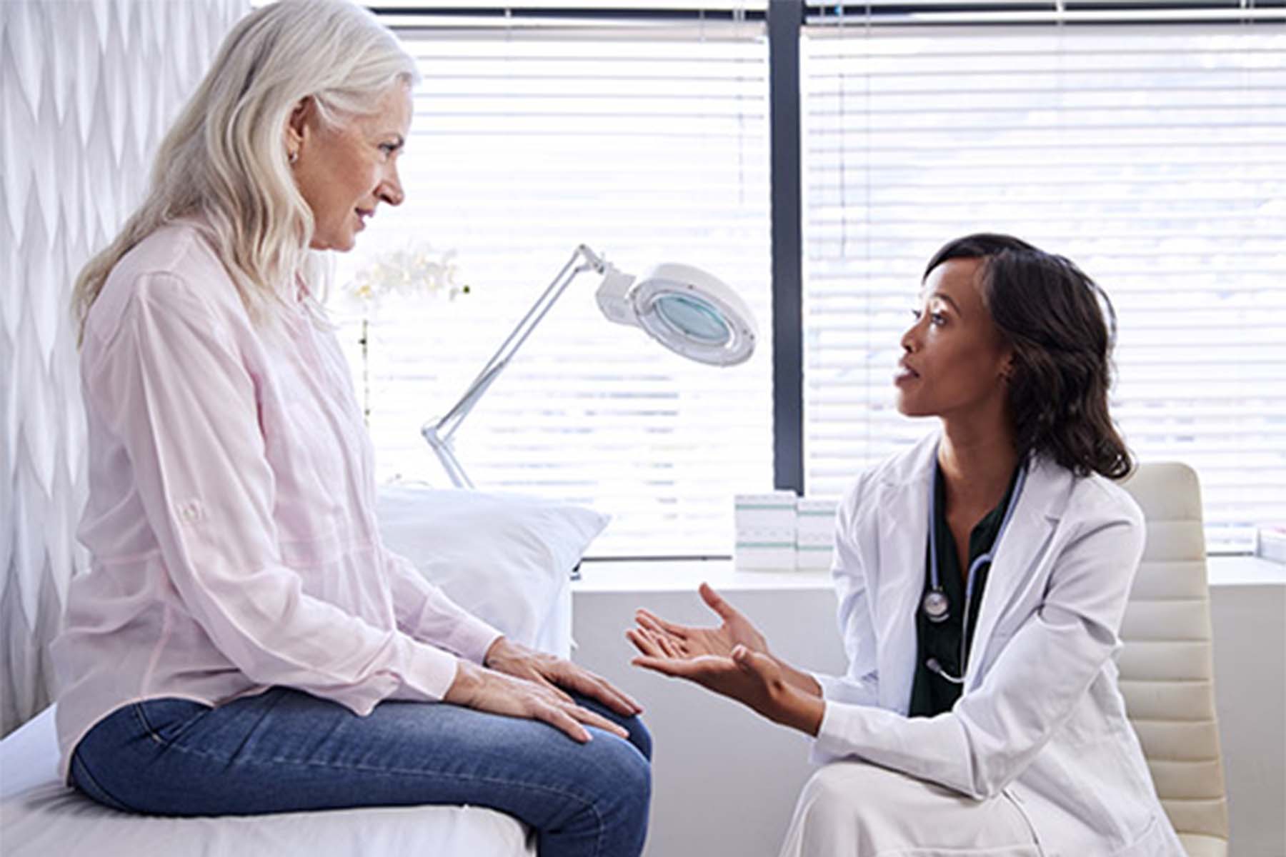 Doctor and patient discussing health concerns in a medical office.