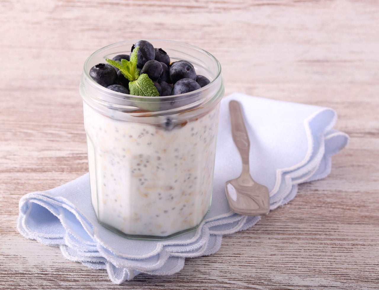 Chia pudding topped with yogurt, blueberries, and fresh mint