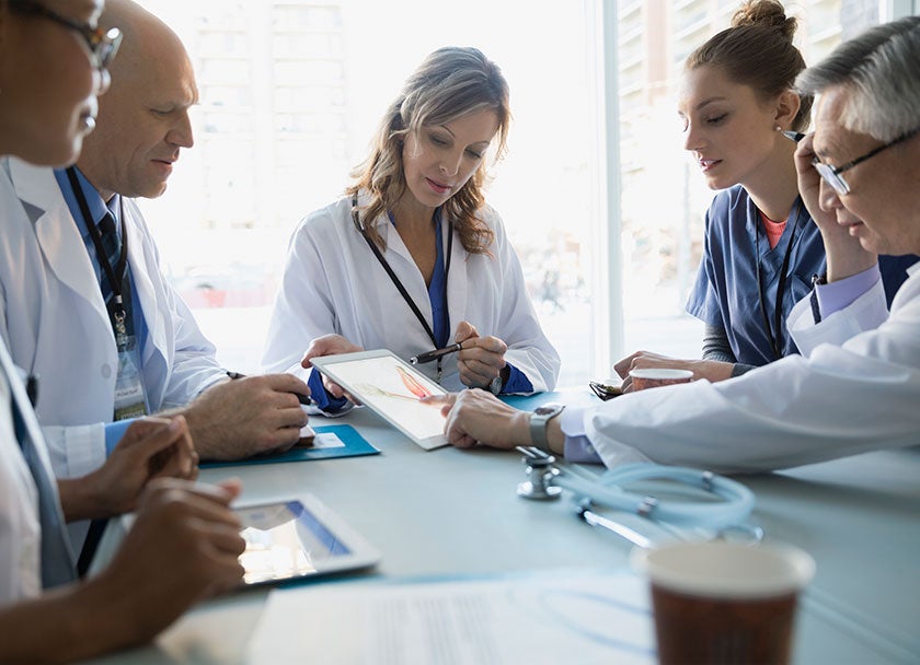 Group of doctors consulting around a table
