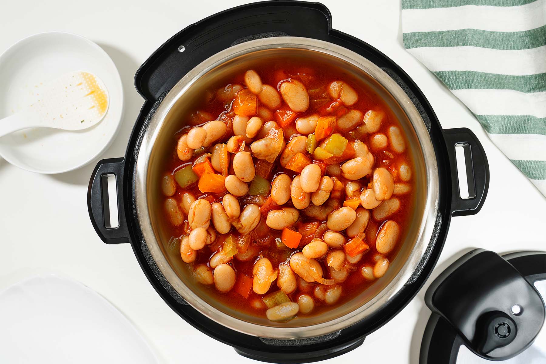 Top view of a pot filled with bean and vegetable stew.