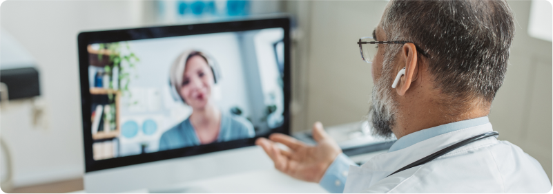 Doctor meeting remotely with his patient