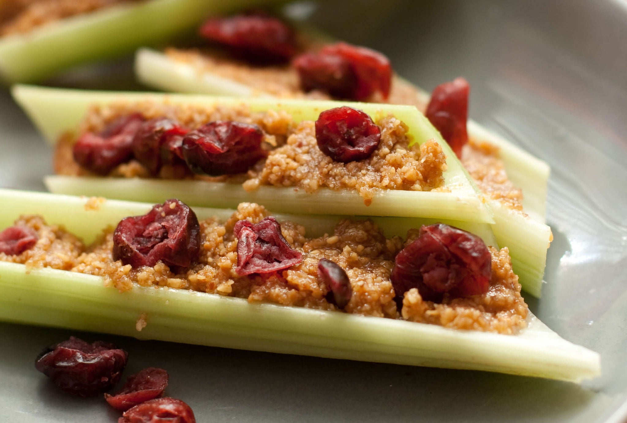 Celery sticks filled with crunchy nut butter topped with dried cherries.