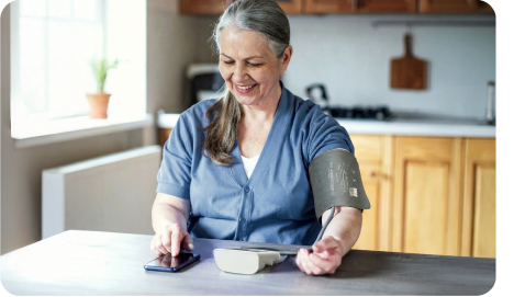  A woman uses a medical device to take her blood pressure reading.